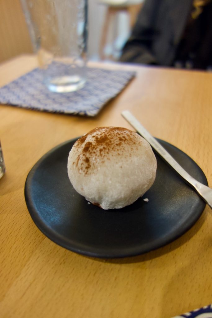 Mochi au chocolat accompagné de sa petite fourchette sur une assiette noire