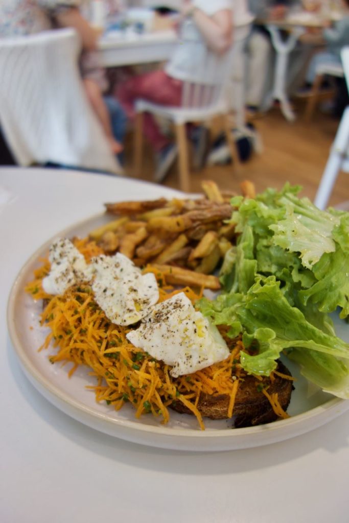 Bruschetta, mozza, carottes râoées, frites et salade dans une assiette banche en grès