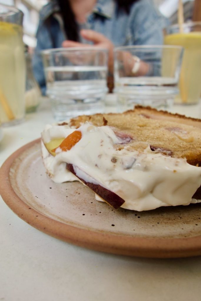 Cake pêche et yaourt dans une assiette en grès marron
