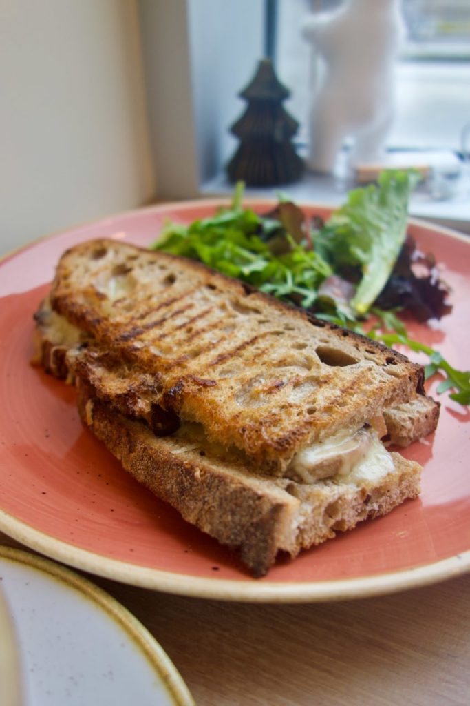 Grilled cheese dans une assiette en grès rouge à liséré écru