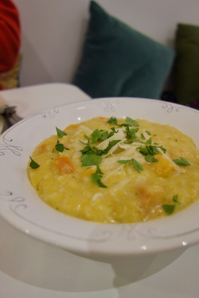 Vue rapprochée sur le risotto dans une assiette blanche creuse vintage