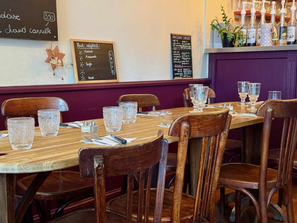 Verres à eau et verres à pied vintage sur une large table rustique en bois